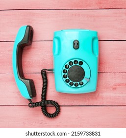 Retro Blue Old Fashioned Rotary Phone On Red Wooden Table. Top View