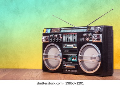 Retro boombox ghetto blaster outdated portable radio receiver with cassette recorder from 80s front gradient colored wall background. Rap, Hip Hop, R&B music concept. Vintage old style filtered photo
