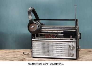 Retro boombox outdated portable black radio receiver with a cassette recorder on the desk
