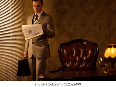 Retro businessman reading newspaper