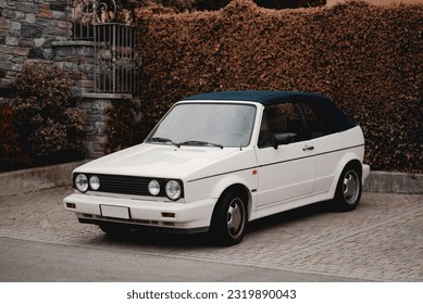 Retro cabriolet. Convertible vehicle. White roofless car. Retracting and storage of the roof.