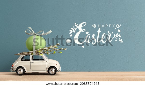 Retro car carrying an easter egg on the roof. Happy\
Easter text