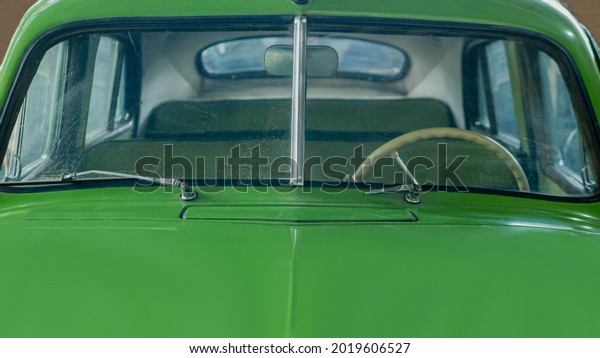 Retro car close up, green car in green color, auto\
windshield old