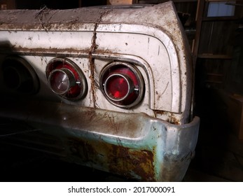 Retro Car Covered In Debris In Old Barn