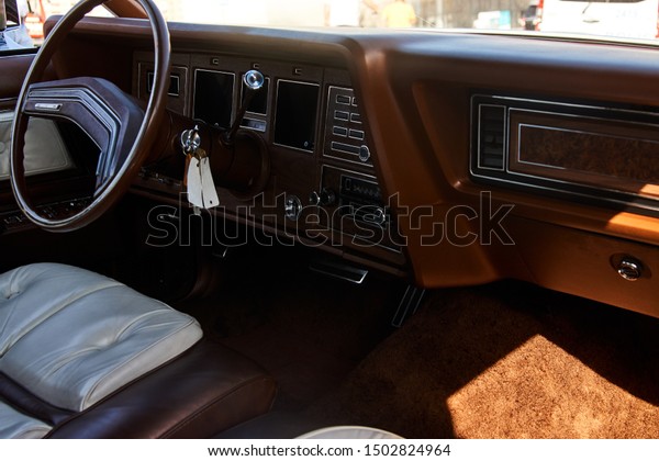 Retro\
car dashboard, close-up. Old automobile interior with brown\
dashboard and leather seats. Rent a car\
concept.