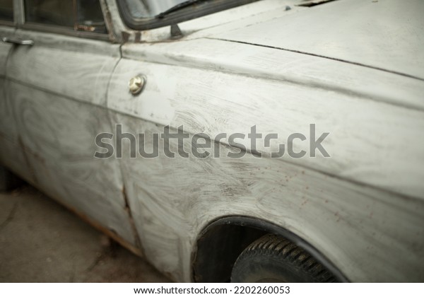 Retro car in gray\
paint. Transport details. Wing of wheel of machine. Transport in\
parking lot. Russian car.