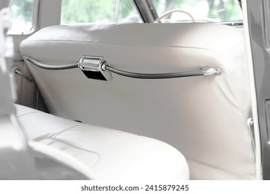 retro car interior. Vintage dashboards. Luxury leather steering wheel. Auto controls.
White interior. Car chairs and seats. Car sofa. Back and front row. Interior and door trim. Classic look - Powered by Shutterstock