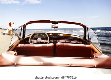 Retro Car On Beach And Two Lovers 