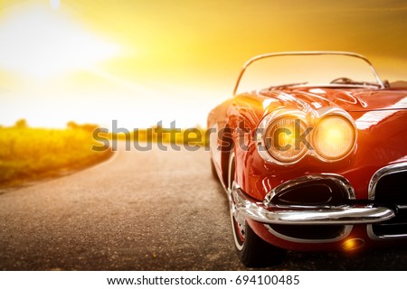 retro car on road and golden autumn space 