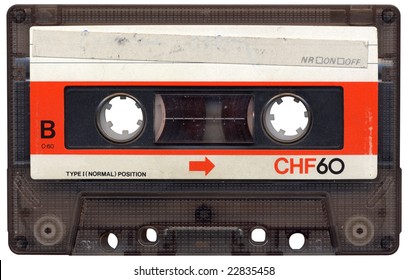 Retro cassette tape from the 80s. All beaten up, faded label colours and dusty.