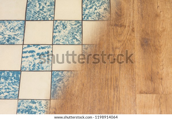 Retro ceramic tiles and modern vinyl\
floor. Housing renovation concept. Contrast of old worn tile facing\
and new wooden flooring texture. Split background. Interior\
reconstruction and\
modernization.