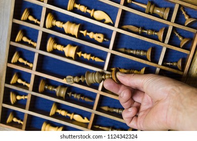 Retro Chess Set Box And A Hand Taking A Piece Out, Studio Closeup