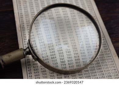 Retro cipher and cryptanalysis. Old vintage magnifying glass with calc table.