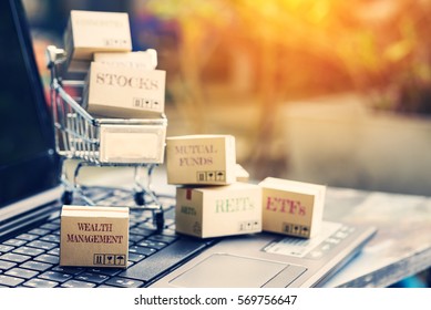 Retro Color Effect : Set Of Cartons Of Financial Products In A Shopping Cart With The One Labelled Wealth Management On A Laptop Keyboard. Online Portfolio Assets Allocation And Management Concept.