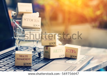 Retro color effect : Set of cartons of financial products in a shopping cart with the one labelled wealth management on a laptop keyboard. Online portfolio assets allocation and management concept.