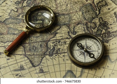 Retro compass with old map and magnifier - Shutterstock ID 746675830