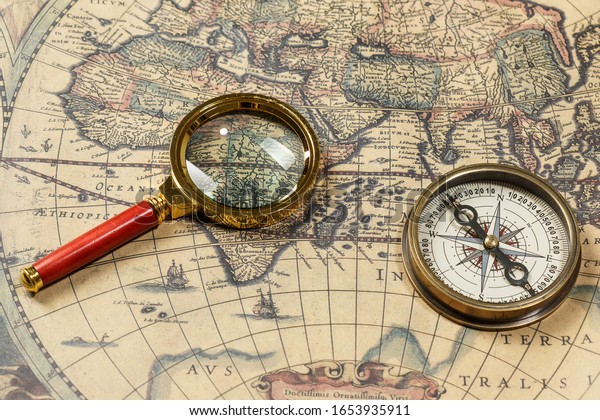 Retro compass with old\
map and magnifier