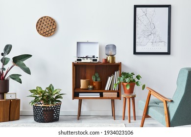 Retro composition of living room interior with mock up poster map, wooden shelf, book, armchair, plant, cacti, vinyl recorder, decoration and personal accessories in stylish home decor. - Shutterstock ID 1934023106