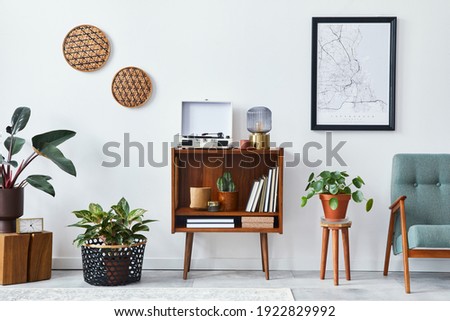 Retro composition of living room interior with mock up poster map, wooden shelf, book, armchair, plant, cacti, vinyl recorder, decoration and personal accessories in stylish home decor.