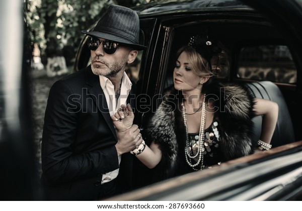 Retro couple with black old\
car