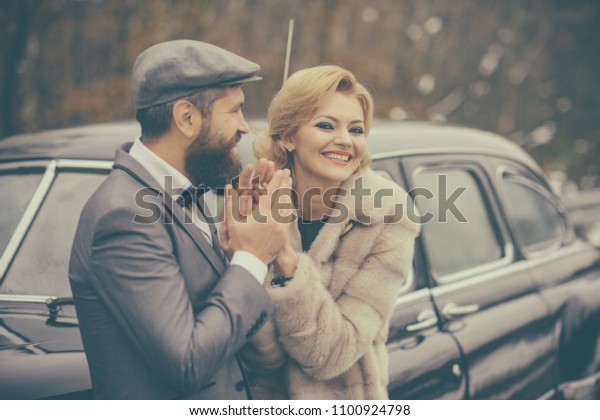 Retro couple\
at classy vintage car with happy\
face