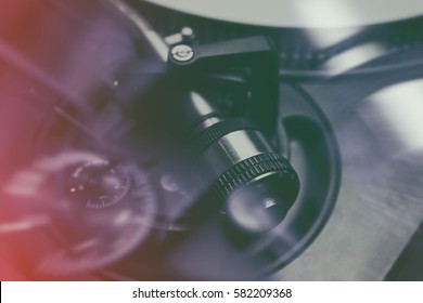 Retro Dj Turntable Close Up.Overhead Shot Of Turntables Tonearm Weigh.Professional Disc Jockey Audio Equipment Closeup.Tone Arm For Hifi Turn Table Needle.Double Exposure Hipster Film Toning Effect