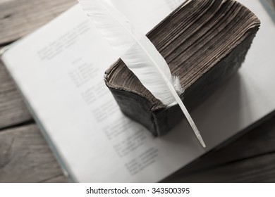 Retro Education Concept. Old Book, Book Of Poems And A Feather. Toned Photo