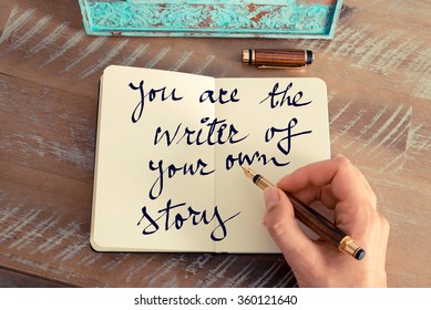 Retro effect and toned image of a woman hand writing a note with a fountain pen on a notebook. Motivational concept with handwritten text YOU ARE THE WRITER OF YOUR OWN STORY