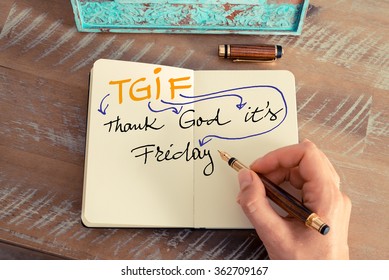 Retro effect and toned image of a woman hand writing a note with a fountain pen on a notebook. Motivational concept with handwritten text TGIF Thank God it's Friday