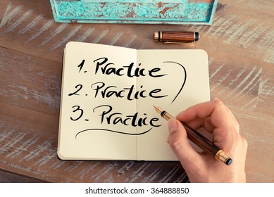 Retro effect and toned image of a woman hand writing a note with a fountain pen on a notebook. Handwritten text PRACTICE, business success concept