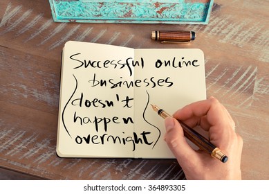 Retro Effect And Toned Image Of A Woman Hand Writing A Note With A Fountain Pen On A Notebook. Handwritten Text SUCCESSFUL ONLINE BUSINESSES DOESN'T HAPPEN OVERNIGHT, Business Success Concept