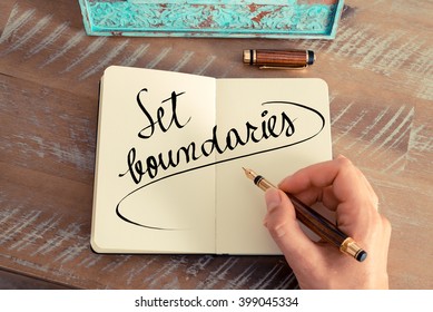 Retro effect and toned image of a woman hand writing a note with a fountain pen on a notebook. Handwritten text Set Boundaries as success and evolution concept image