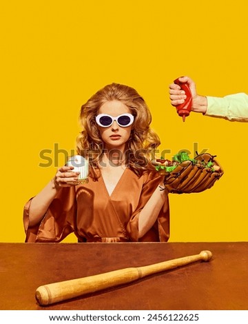 Retro fashion woman holding hot dog in baseball glove and waiter add more sauce to her dish against yellow background. Concept of sport, active lifestyle and healthy eating, contemporary art.