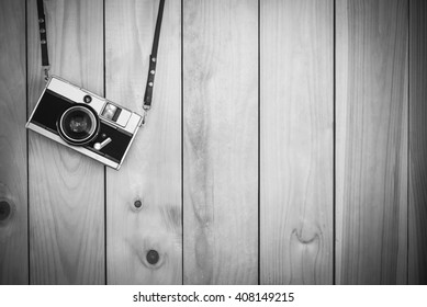 Retro film cameras holding on wood background with free copy spa - Powered by Shutterstock