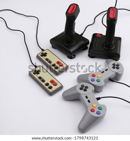 Retro gamepads and joysticks on white background. Video game, gaming 80s.
