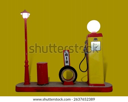 Retro gas station setup featuring a vintage pump, air machine, and classic lamp post on yellow.