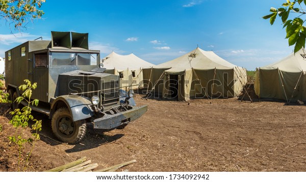 Retro\
german World War II military truck Krupp L3H163 is standing near a\
row of old canvas tents in a military camp. Nedvigovka,\
Rostov-on-Don region / Russia - 30 august\
2013.