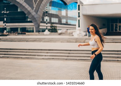 Retro Girl With Sports Clothes Roller Skating Near Office Buidlings