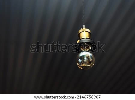 retro glass light bulb in dark room with copy space place