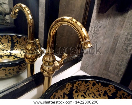 Retro golden faucet in the bathroom