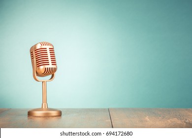 Retro golden microphone for press conference or interview on table front gradient mint green background. Vintage old style filtered photo - Shutterstock ID 694172680