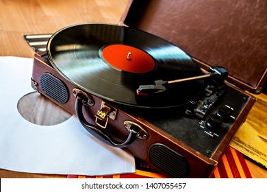 Retro gramophone in case with vinyl playing close up