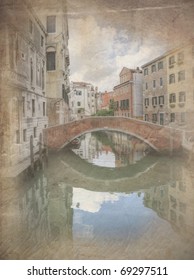 Retro grunge effect photo of Reflections in still canal of bridge and old buildings in Venice Italy