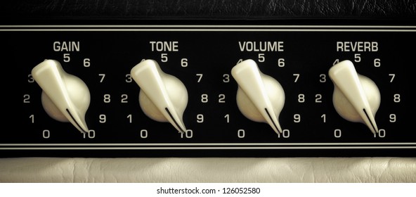 retro guitar amplifier control panel, maximum position, close up