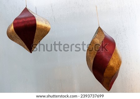 retro holiday twirly decorative objects pinned to a window