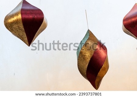 retro holiday twirly decorative objects pinned to a window