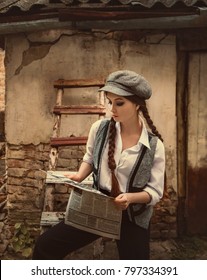 Retro hooligan girl reads newspaper. Vintage businesswoman. woman is dressed like a man, vintage retro style. Great Depression. fashion clothing 20s 30s.The Peaky Blinders. Clothes shirt black pants