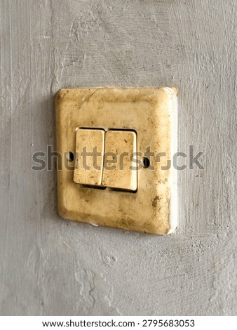 Retro Household Light Switch Toggle on Grunge Plaster Wall