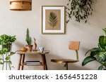 Retro interior design of living room with stylish vintage chair and table, plants, cacti, personal accessories and gold mock up poster frame on the beige wall. Elegant home decor. Template. 