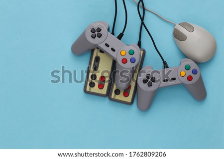 Retro joysticks and pc mouse on blue background. Retro gaming, gaming devices, gadgets